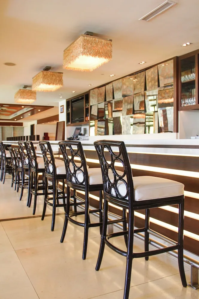 Bar counter with high-back stools and pendant lights at Ko'a Kea Resort on Po'ipu Beach.