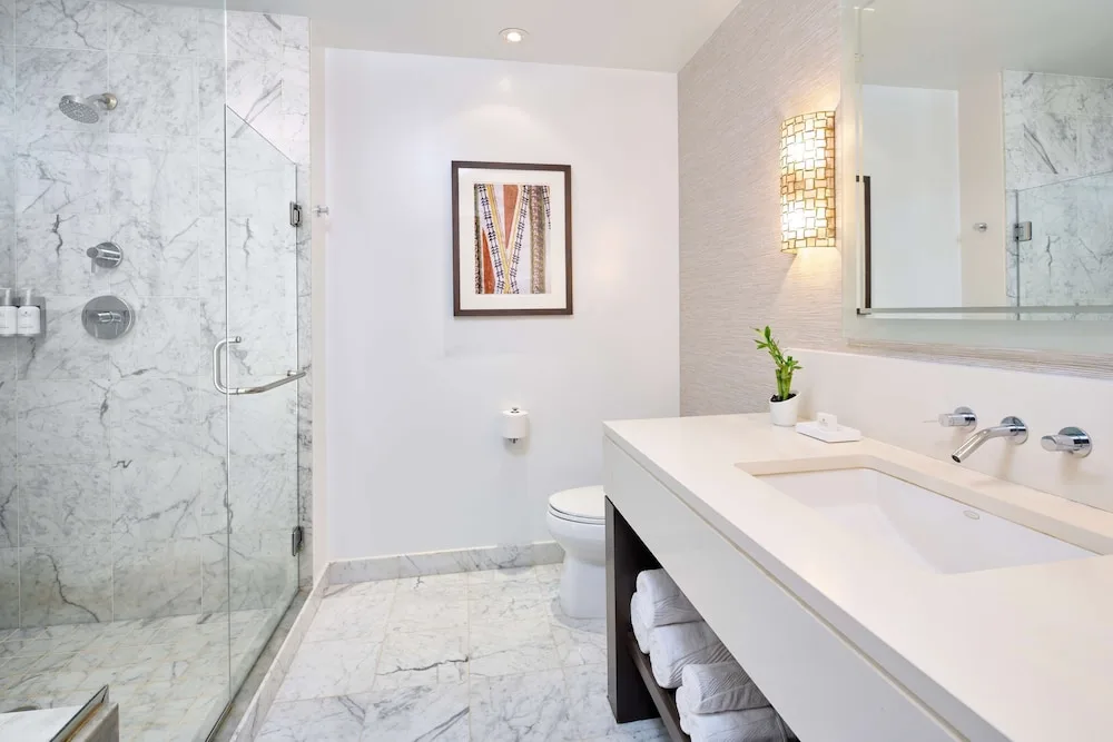 Garden View bathroom with glass shower and vanity at Ko'a Kea Resort on Po'ipu Beach.