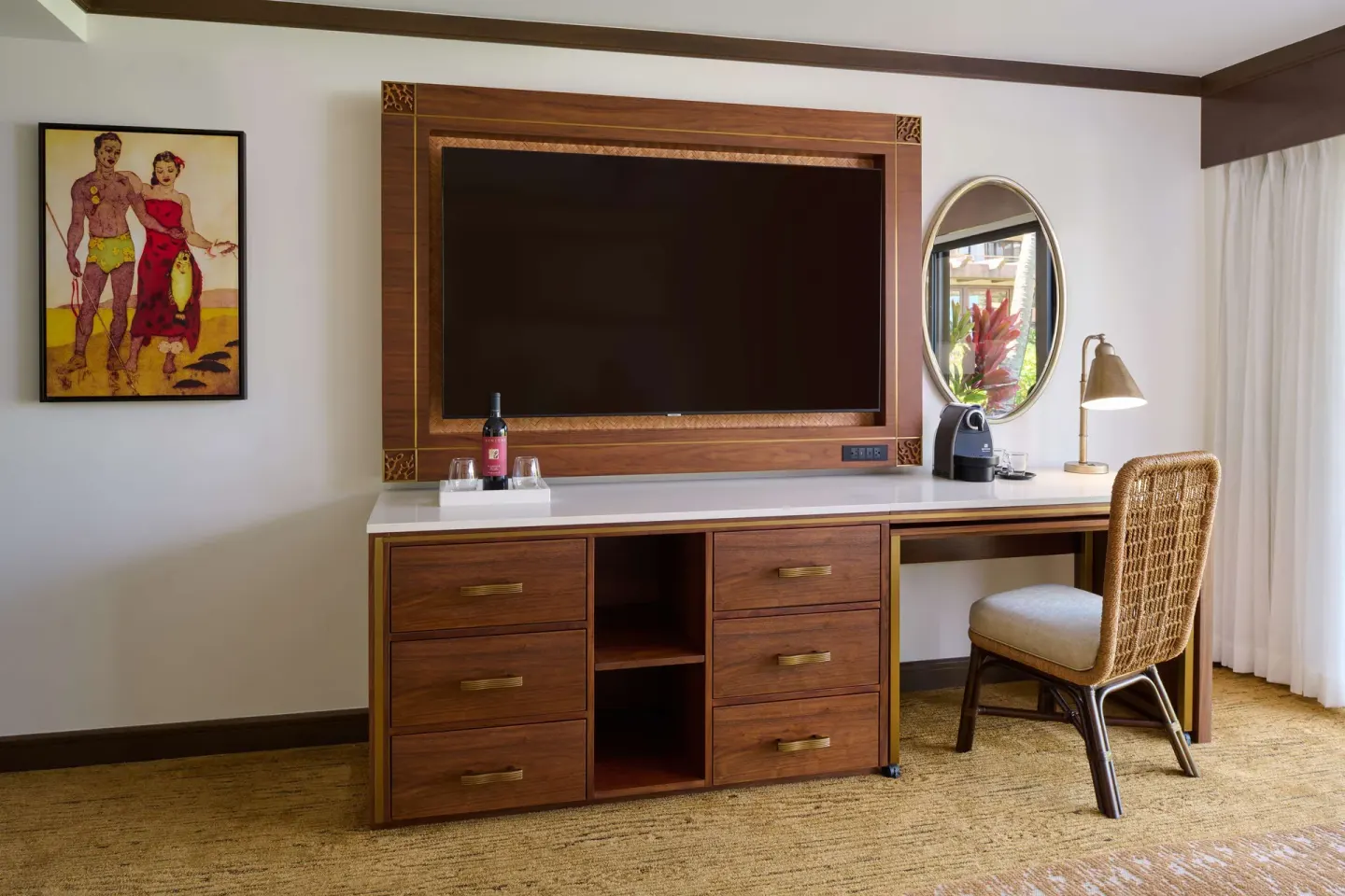 Dresser, television, desk, and mirror in a guest room at Ko'a Kea Resort on Po'ipu Beach.