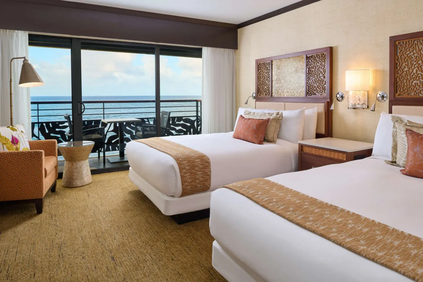 Oceanfront room with two beds and balcony view at Ko'a Kea Resort on Po'ipu Beach.