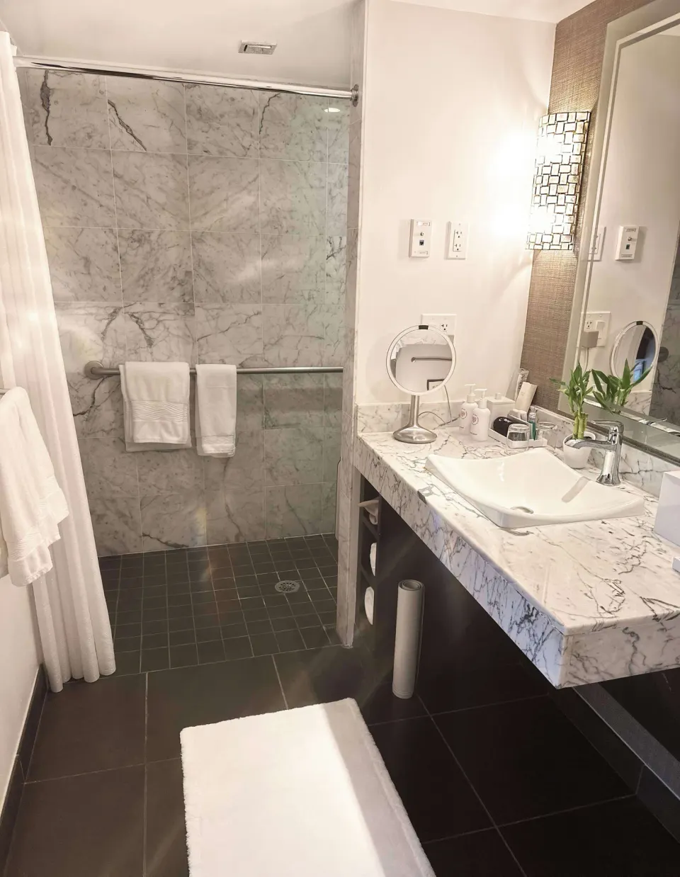 Marble bathroom vanity and walk-in shower in an ocean-view suite at Ko'a Kea Resort on Po'ipu Beach.