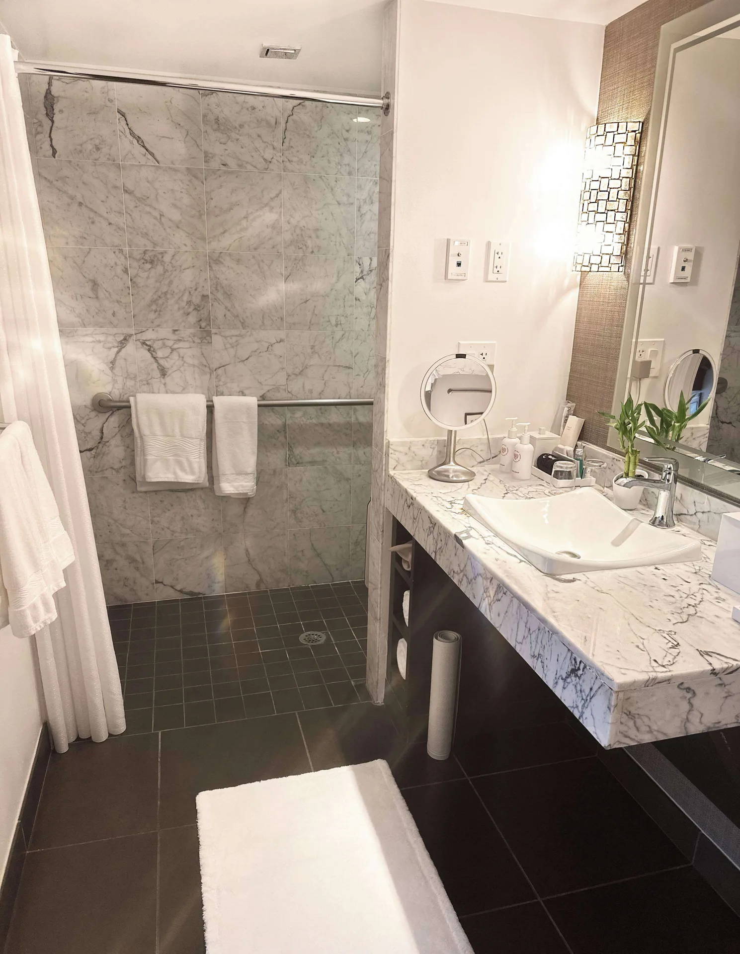 Marble bathroom vanity and walk-in shower in an ocean-view suite at Ko'a Kea Resort on Po'ipu Beach.