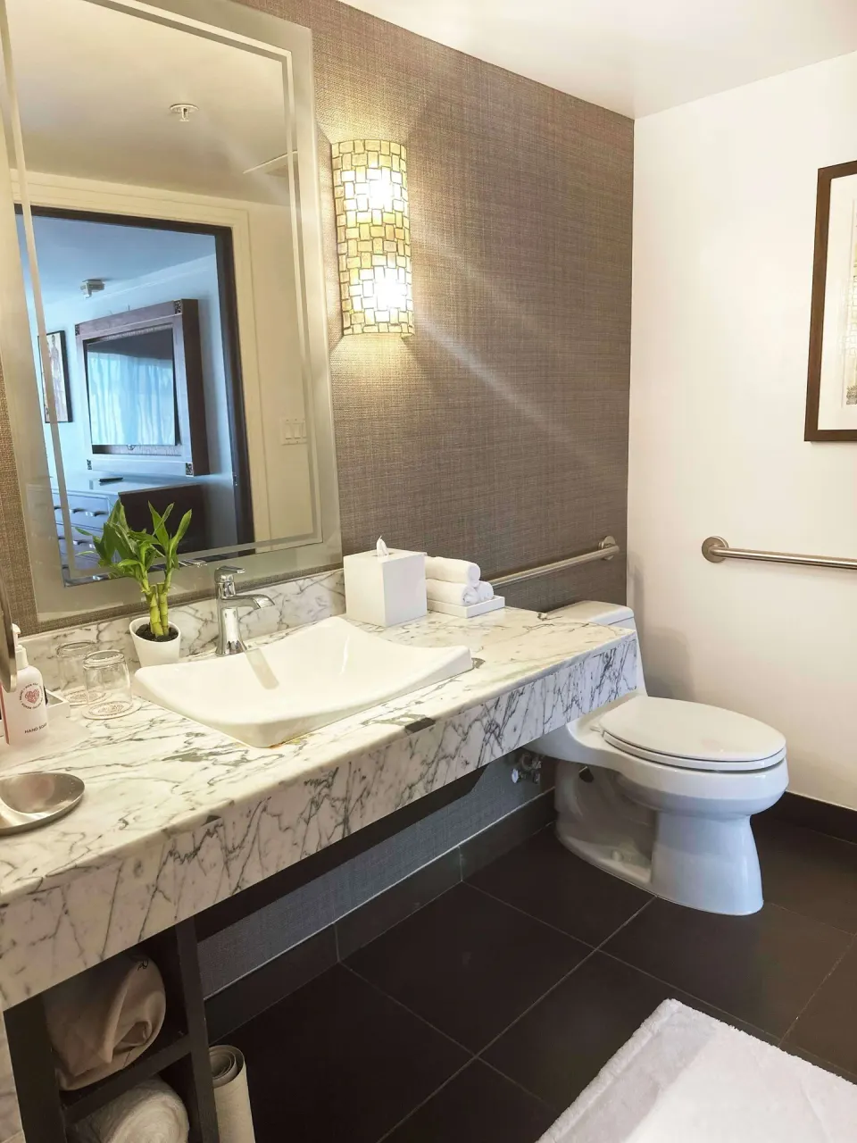 Bathroom vanity and toilet in an ocean-view suite at Ko'a Kea Resort on Po'ipu Beach.