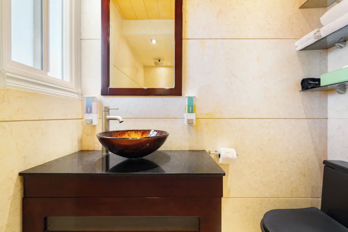 Bathroom vanity with vessel sink and mirror at Kokomo Botanical Resort.