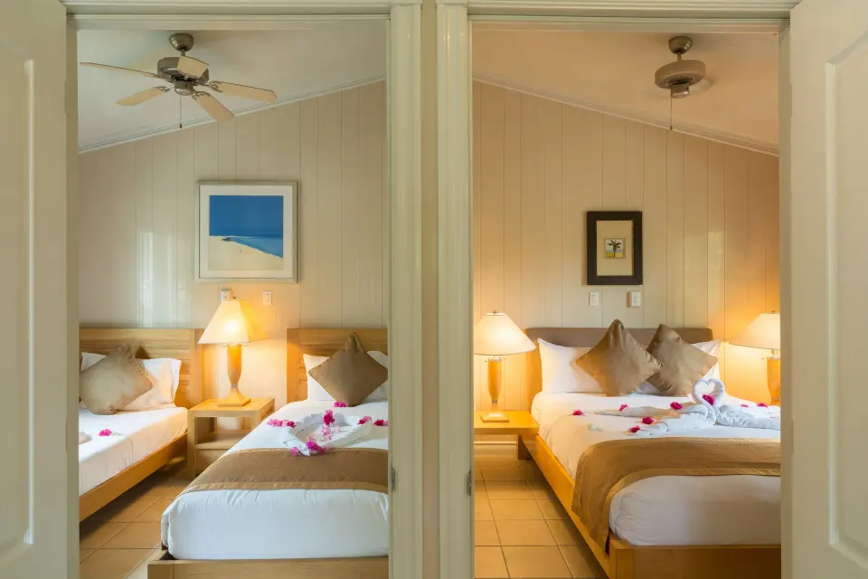 Connecting guest bedrooms with a king bed and twin beds at Kokomo Botanical Resort.