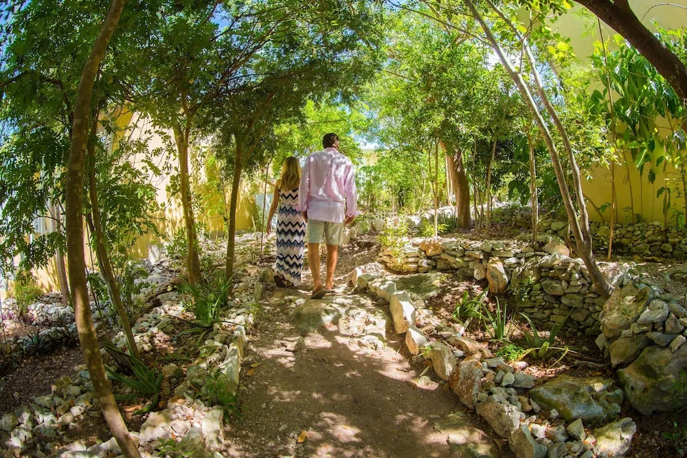 Couple walking a stone garden path at Kokomo Botanical Resort.