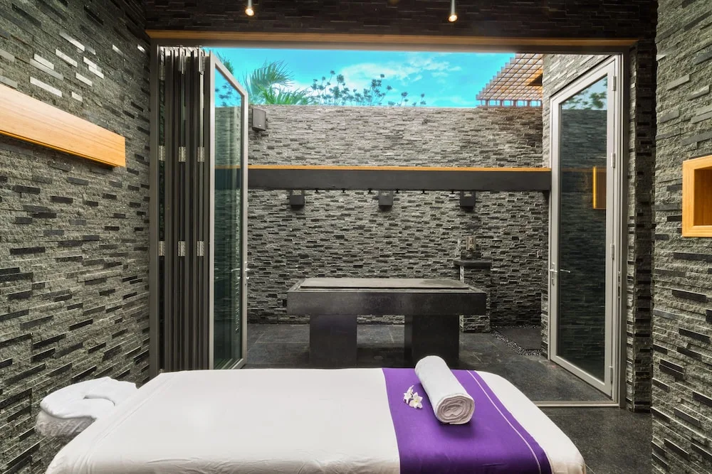 Spa treatment bed facing an open private courtyard at Kokomo Botanical Resort.