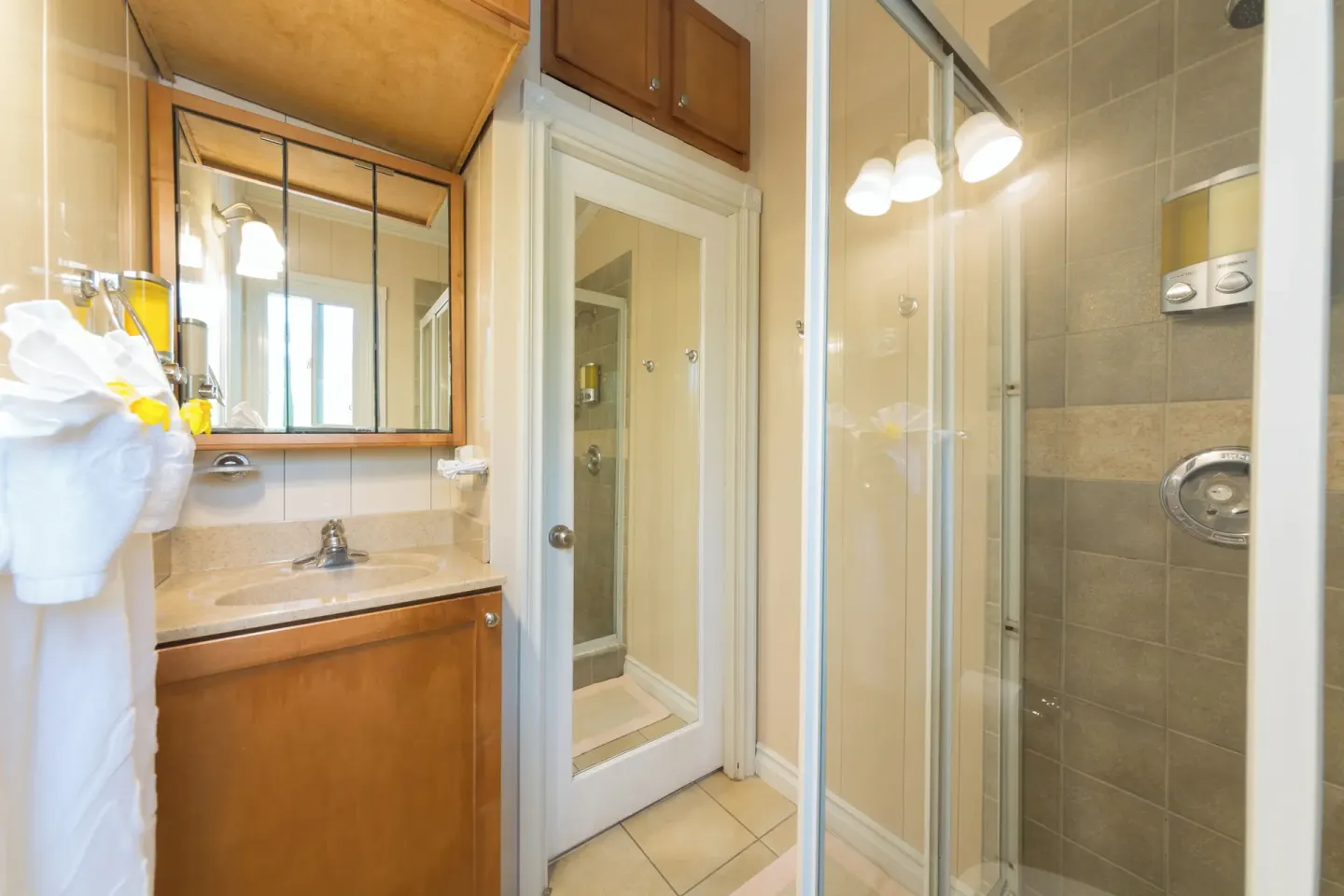Bathroom vanity and glass shower in a Deluxe Cottage at Kokomo Botanical Resort.