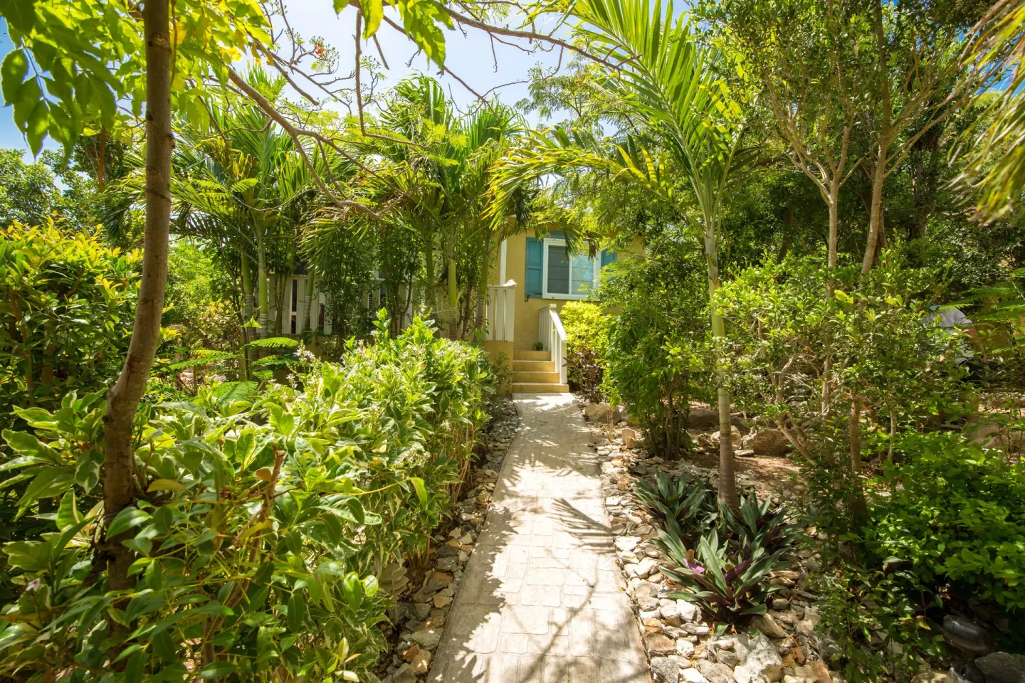 Garden path leading to a deluxe two-bedroom cottage at Kokomo Botanical Resort.