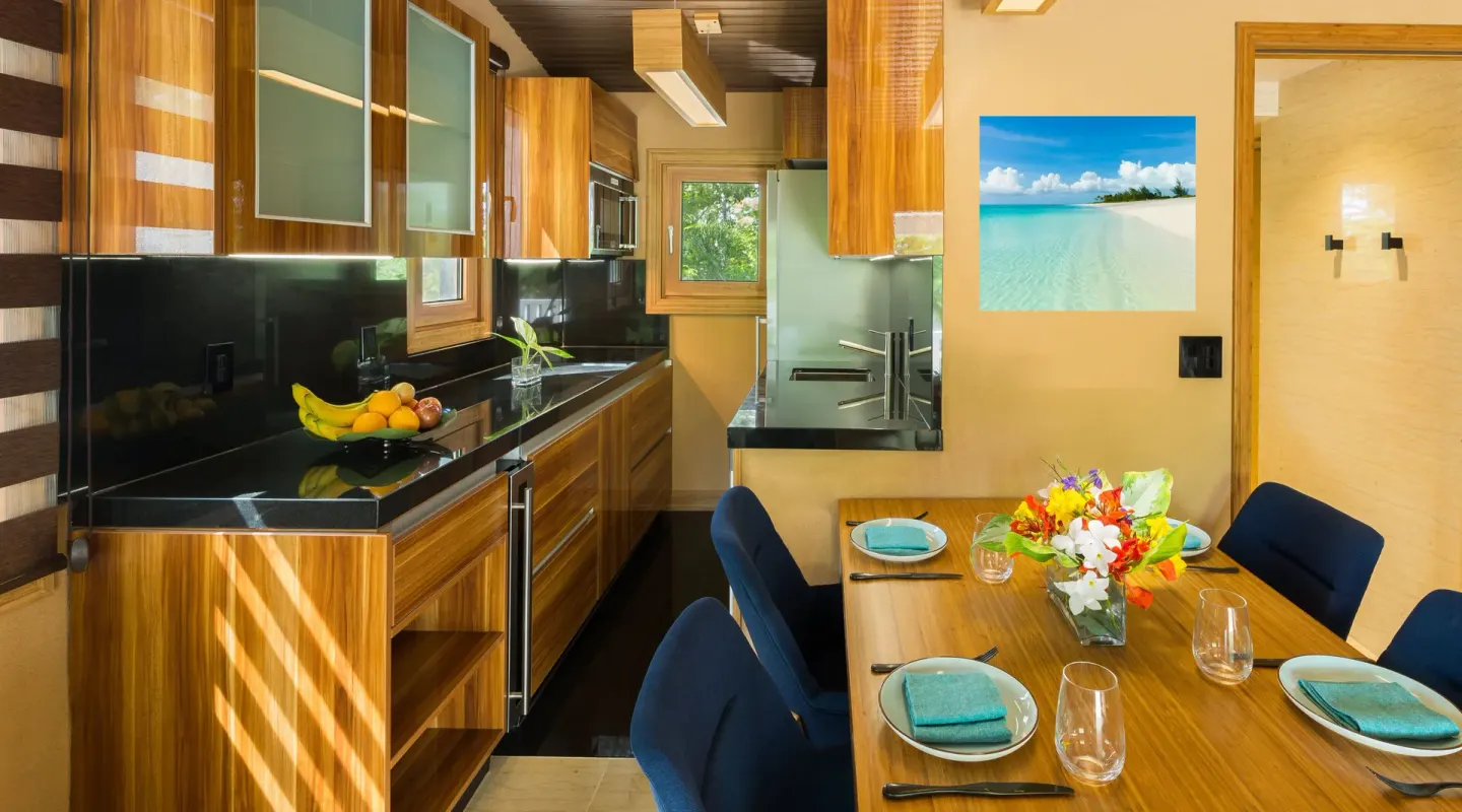 Superior Cottage kitchen and dining table set for four at Kokomo Botanical Resort.
