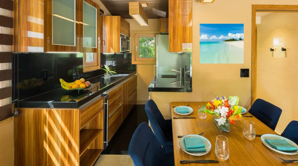 Superior Cottage kitchen and dining table set for four at Kokomo Botanical Resort.