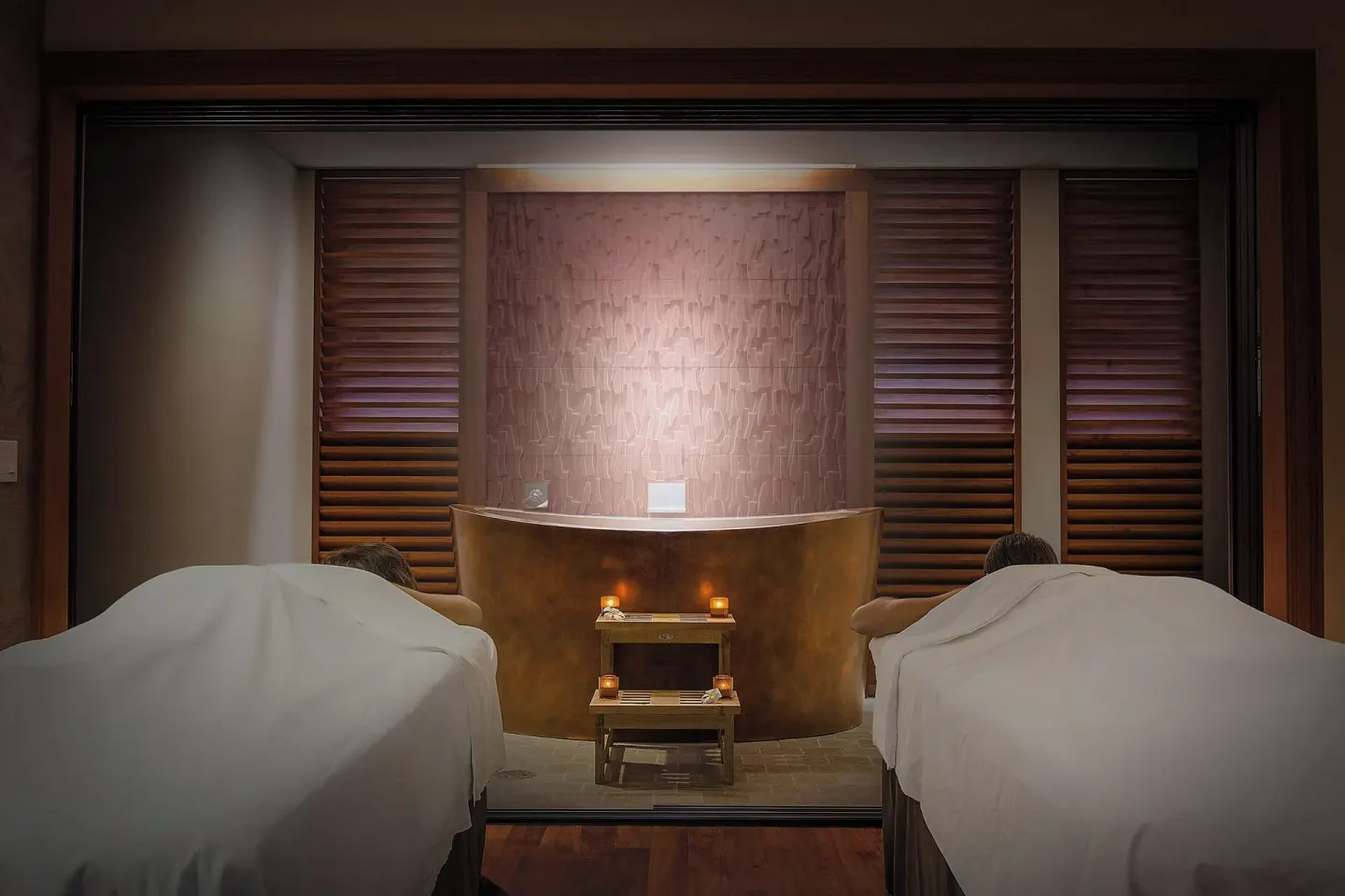 Couples spa treatment room with two massage tables and candles at Koloa Landing Resort at Poipu.