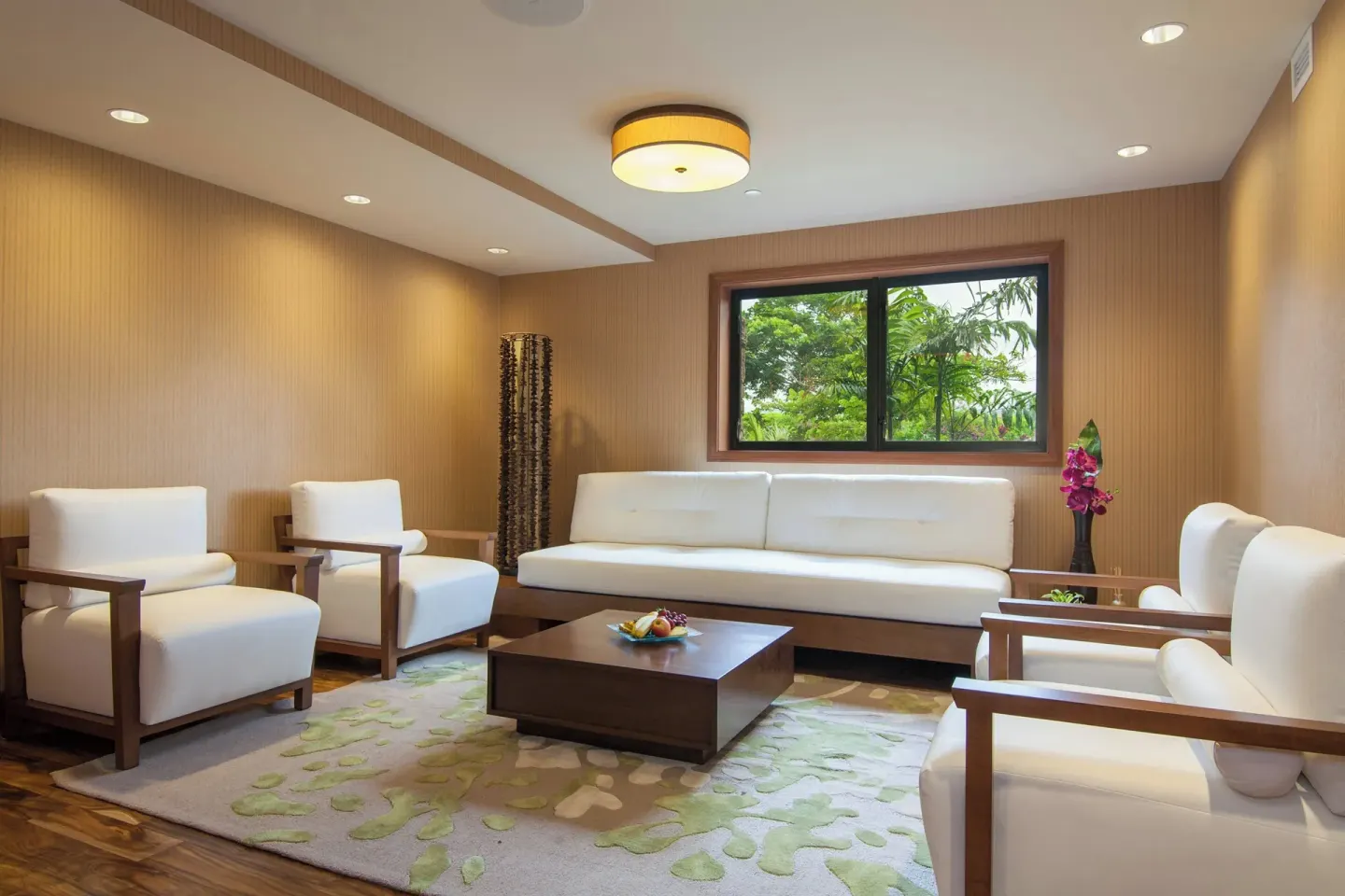 Lounge seating with white chairs, sofa, coffee table, and garden window at Koloa Landing Resort at Poipu.