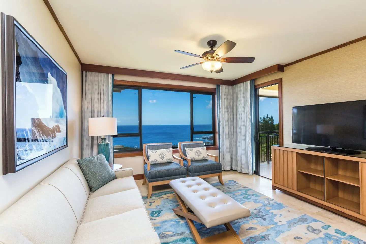 Ocean-view suite living room with sofa and chairs at Koloa Landing Resort at Poipu.