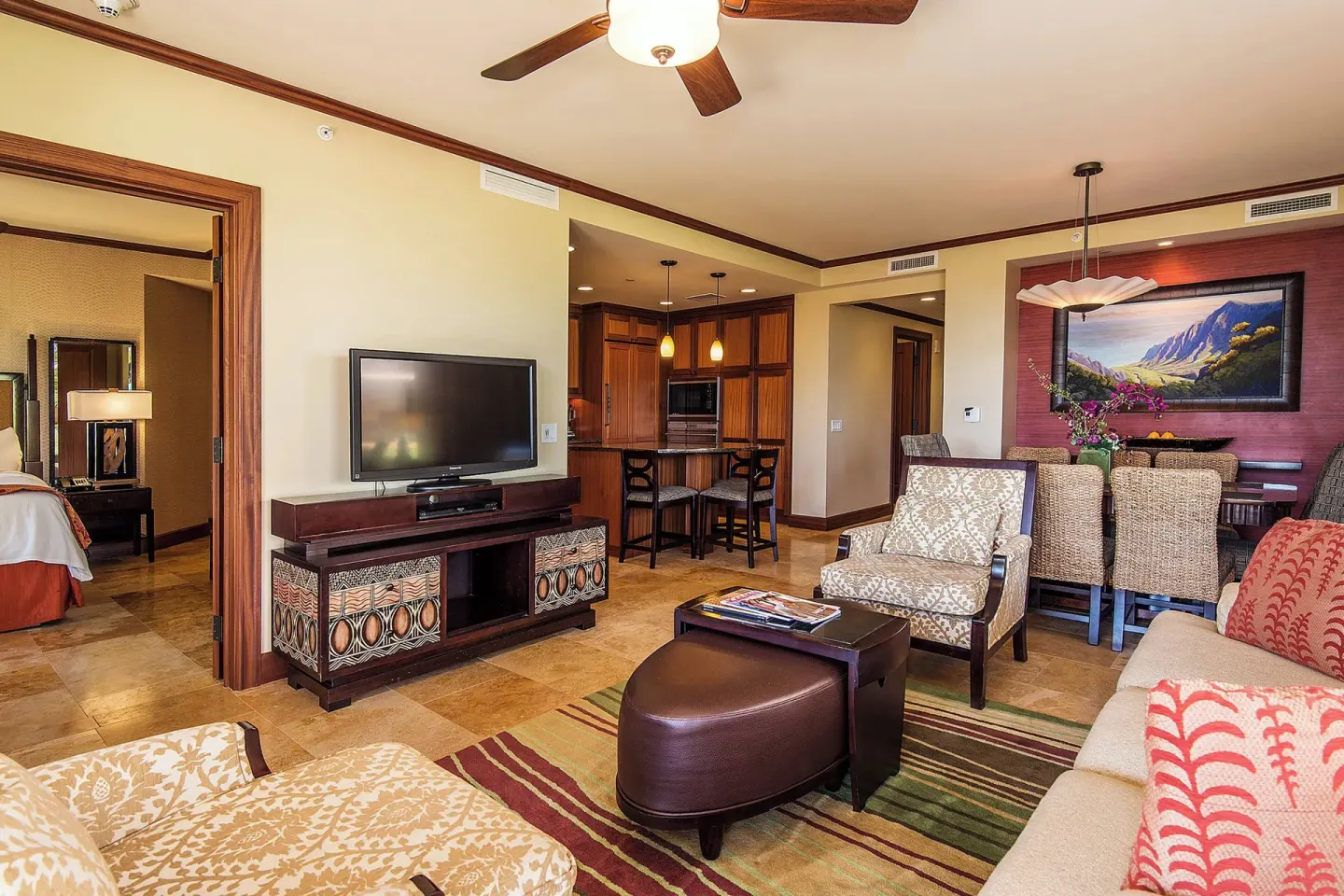 Suite living and dining area with kitchen and bedroom doorway at Koloa Landing Resort at Poipu.