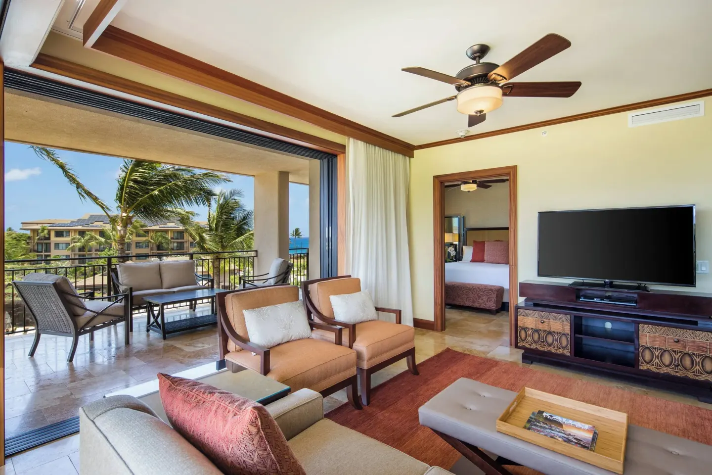 Suite living room and lanai with palm views at Koloa Landing Resort at Poipu.