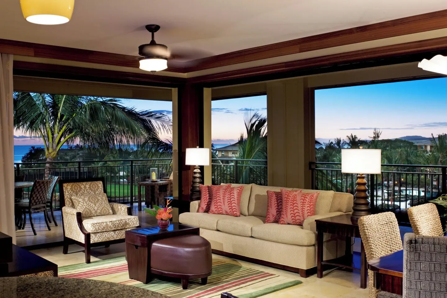 Suite living room with wraparound lanai and ocean at dusk at Koloa Landing Resort at Poipu.