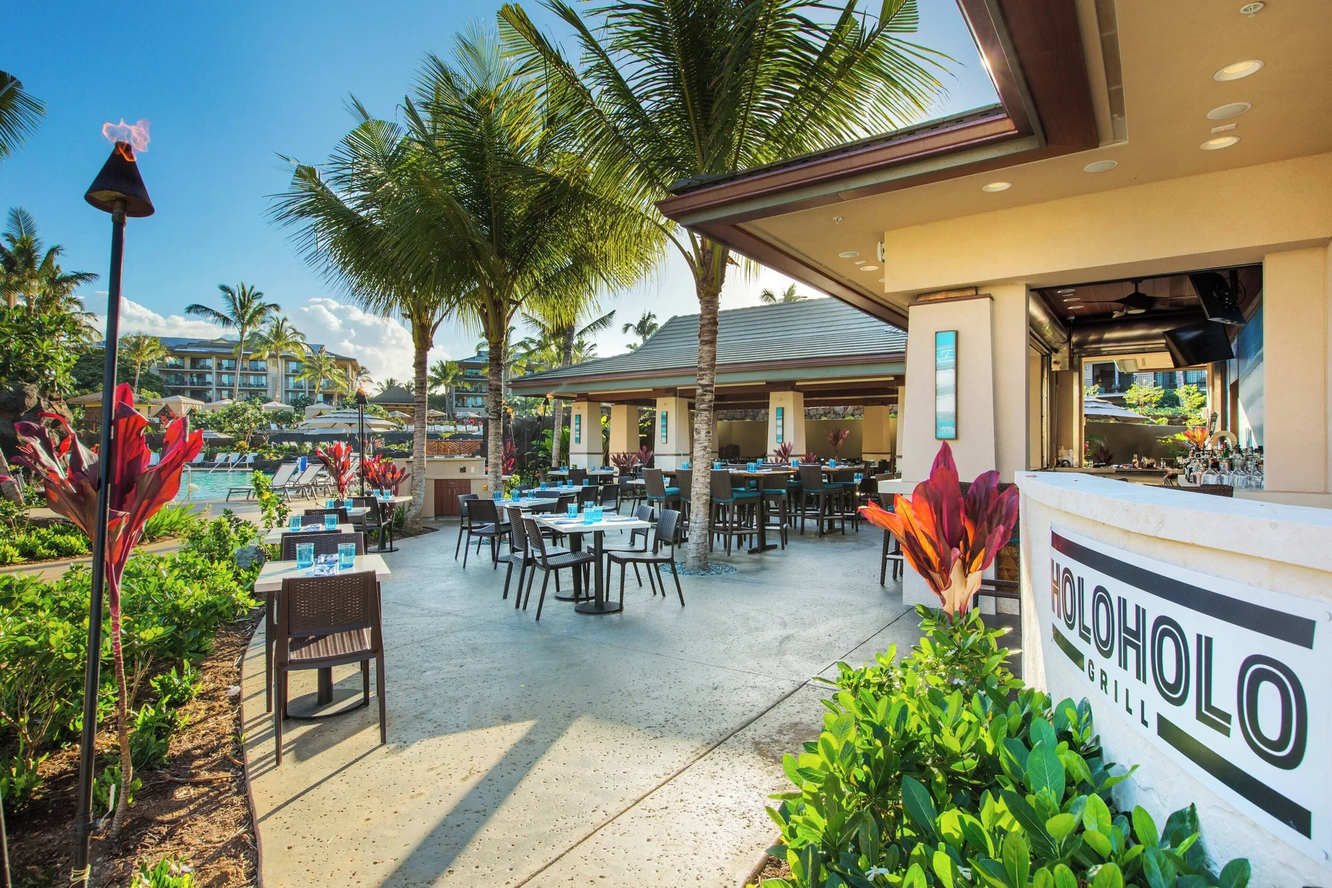Holoholo Grill patio and poolside tables at Koloa Landing Resort at Poipu.