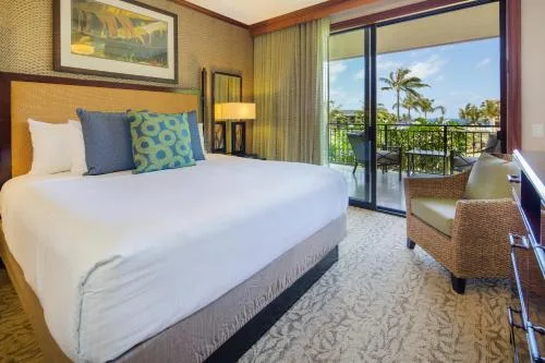Bedroom with king bed and balcony view in a 2 Bedroom Villa at Koloa Landing Resort at Poipu.
