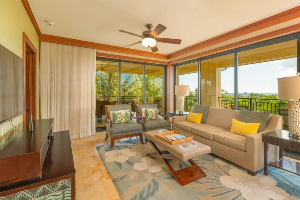 Coastline view villa living room with lanai windows at Koloa Landing Resort at Poipu.