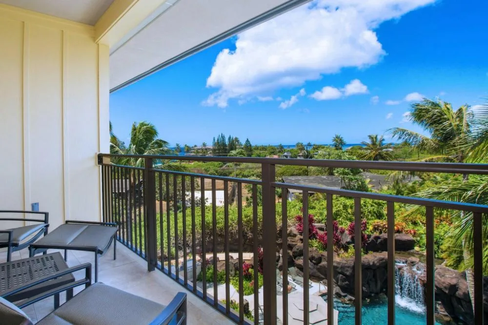 Balcony with lounge seating and coastline view at Koloa Landing Resort at Poipu.