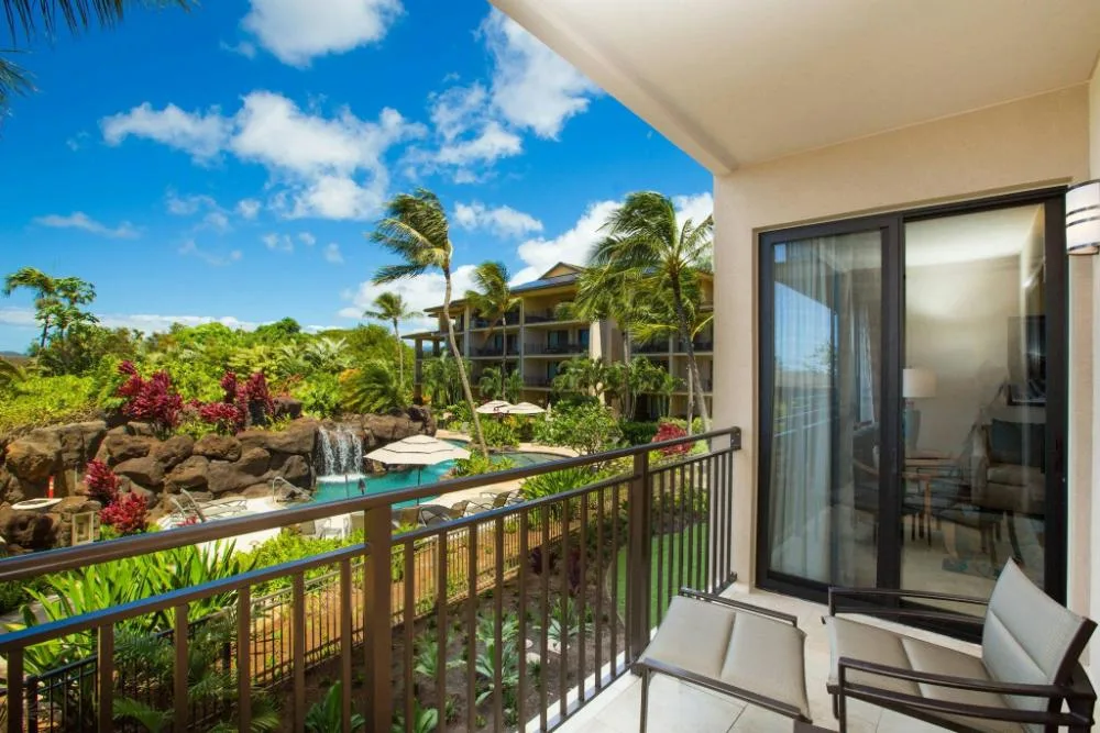 Furnished balcony with island landscaping and pool view at Koloa Landing Resort at Poipu.
