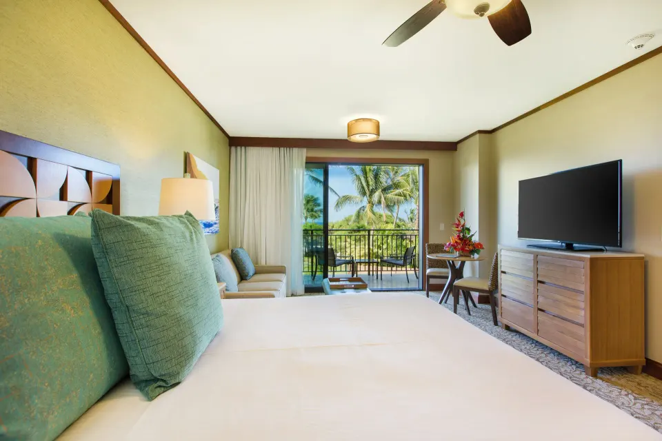 Studio king bed with sofa bed, TV and lanai view at Koloa Landing Resort at Poipu.