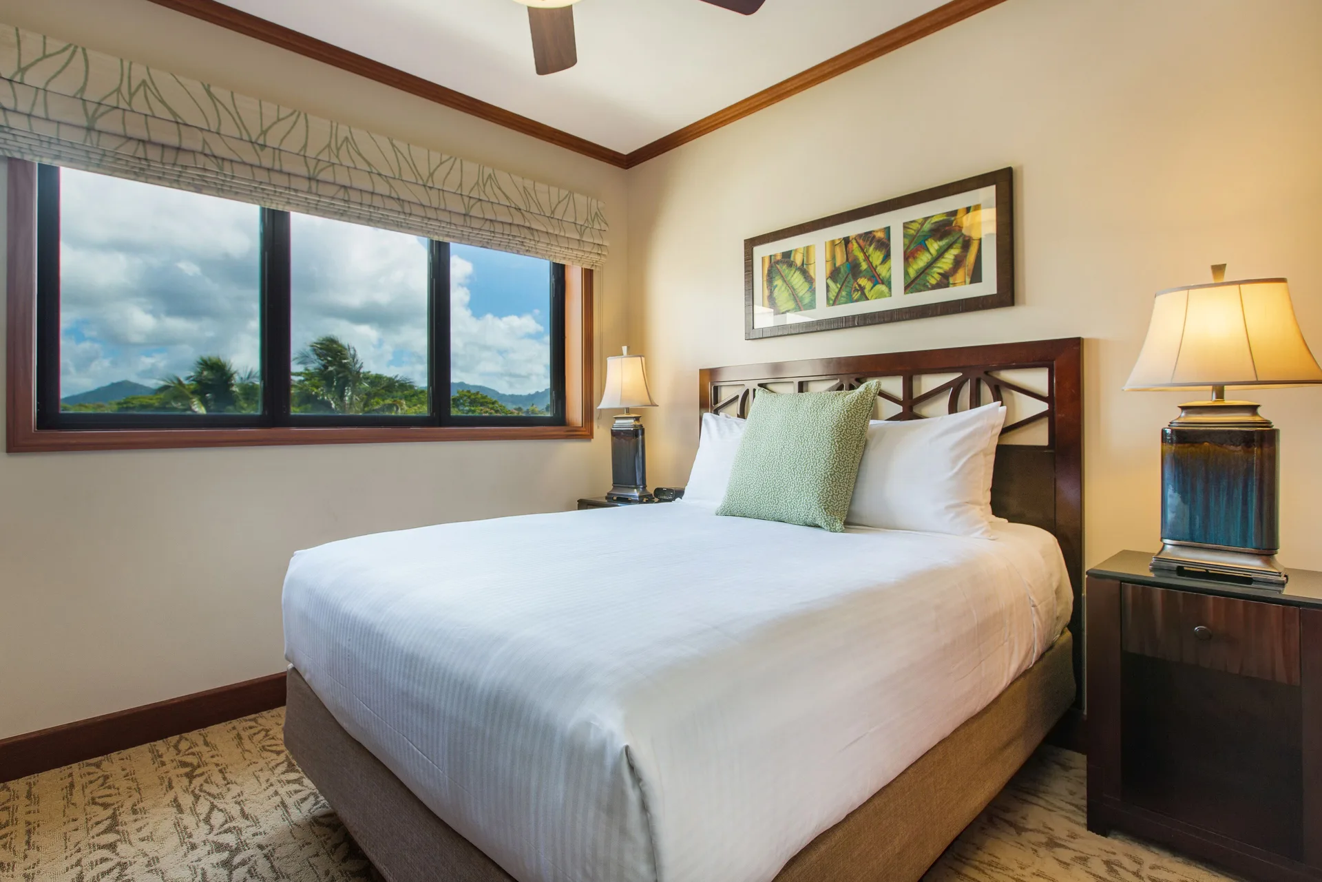 Second bedroom with queen bed and wide window at Koloa Landing Resort at Poipu.