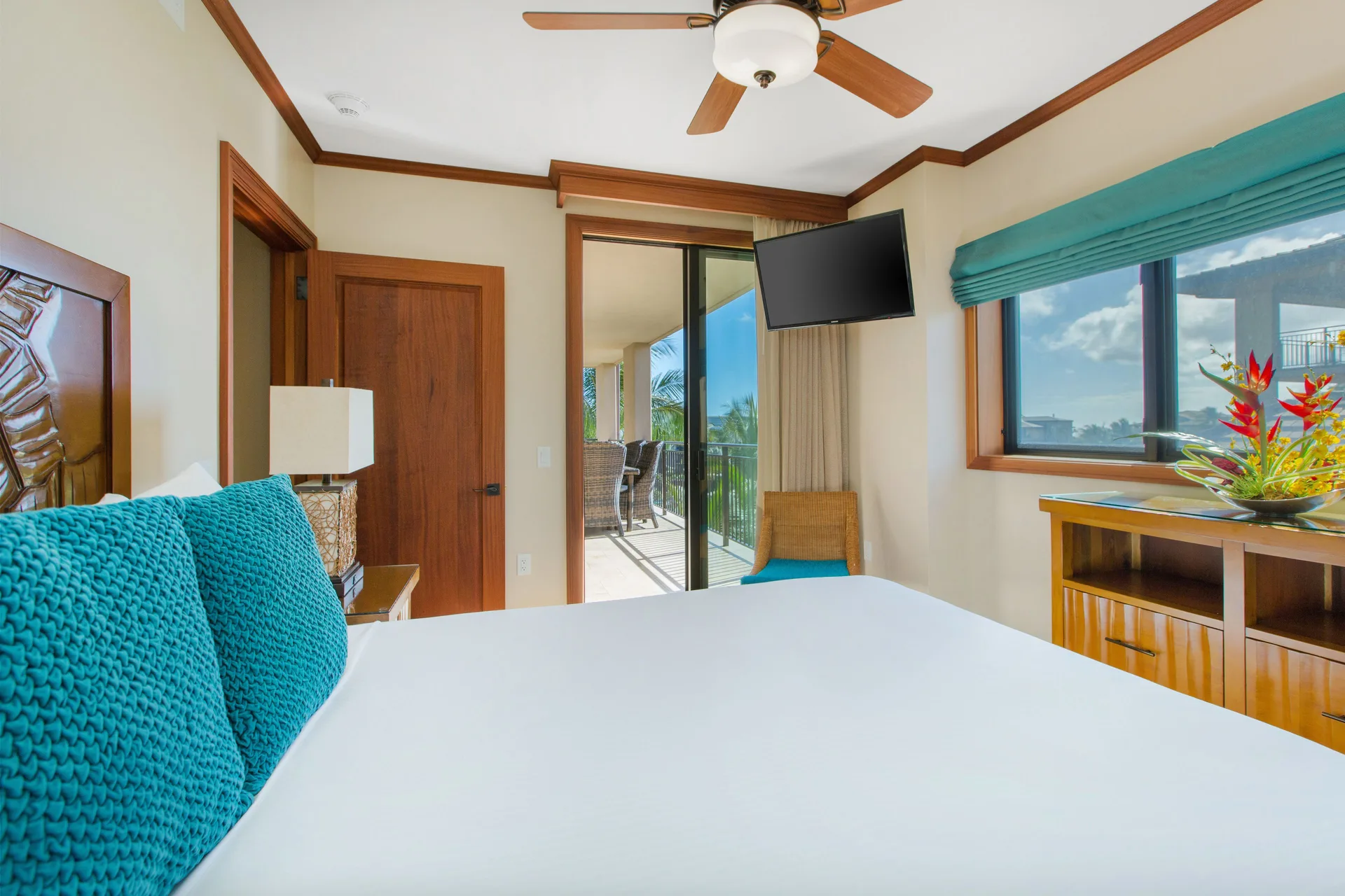 Guest bedroom with balcony access at Koloa Landing Resort at Poipu.