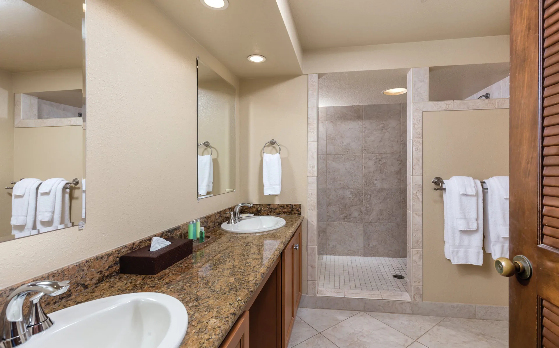 One Bedroom Villa Honu bathroom vanity with double sinks and walk-in shower at Kona Coast Resort.
