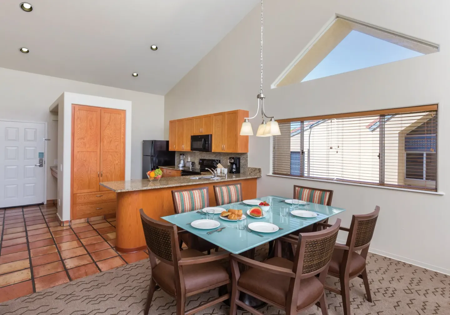 One Bedroom Villa Honu dining area and full kitchen at Kona Coast Resort.