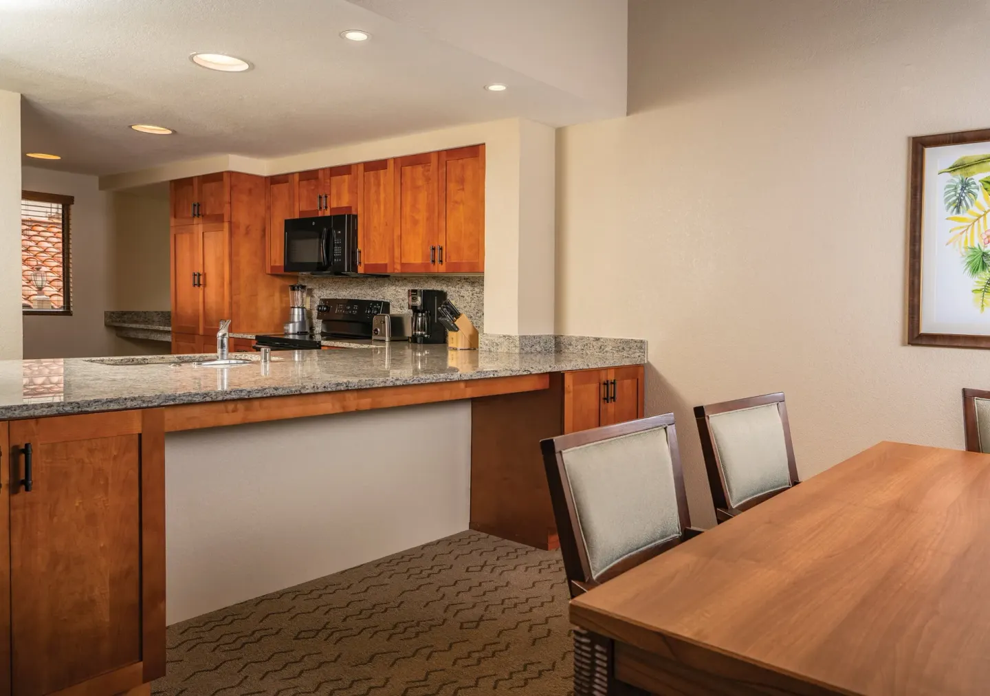 One Bedroom Villa Honu kitchen counter and dining table at Kona Coast Resort.
