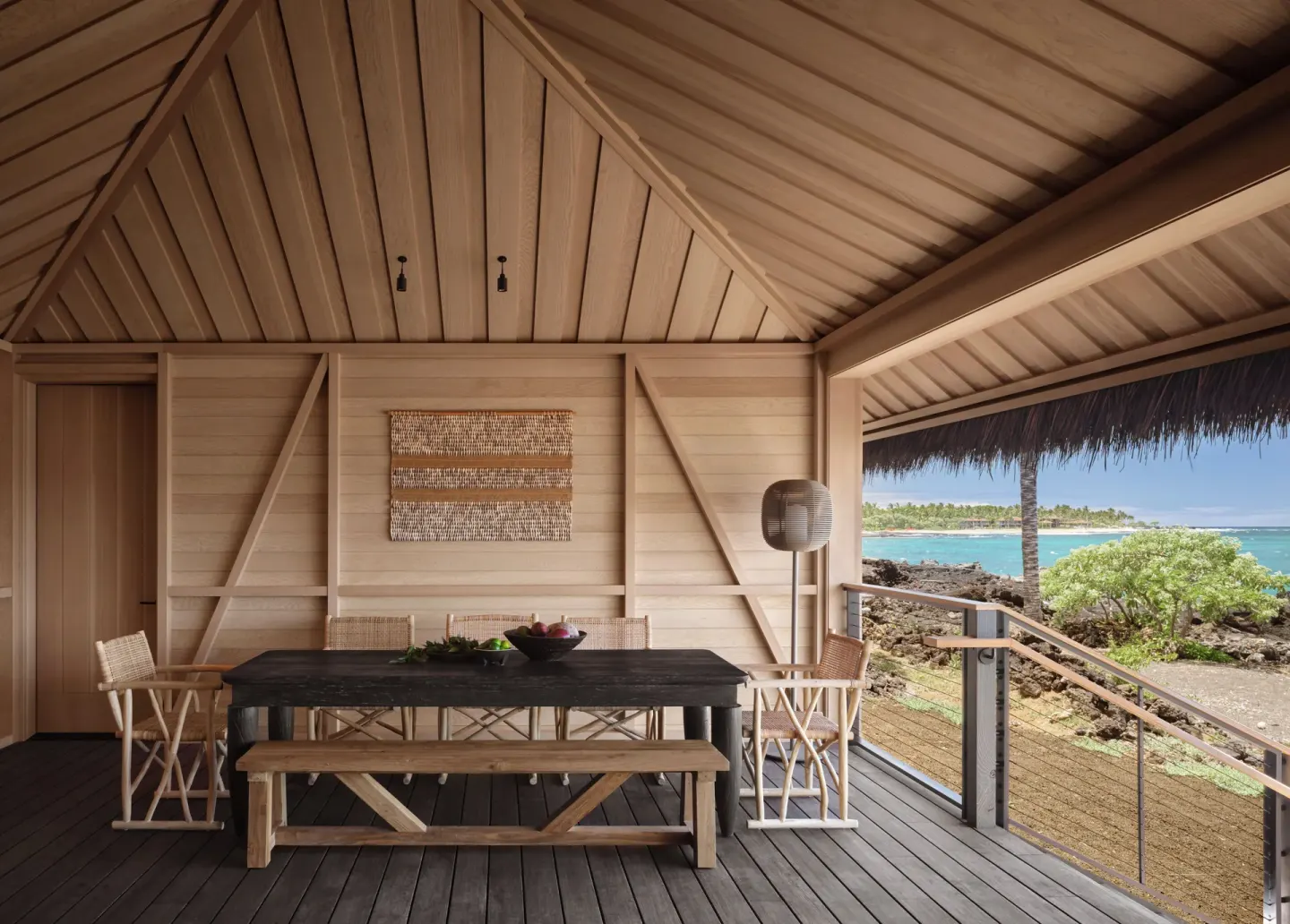 Covered guest room lanai dining table with ocean view at Kona Village.