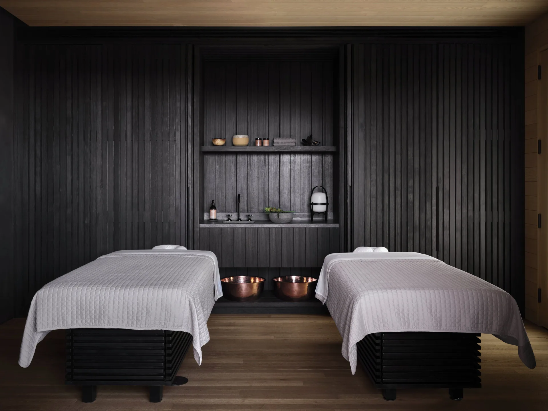 Two spa treatment tables with shelves and copper bowls at Kona Village.