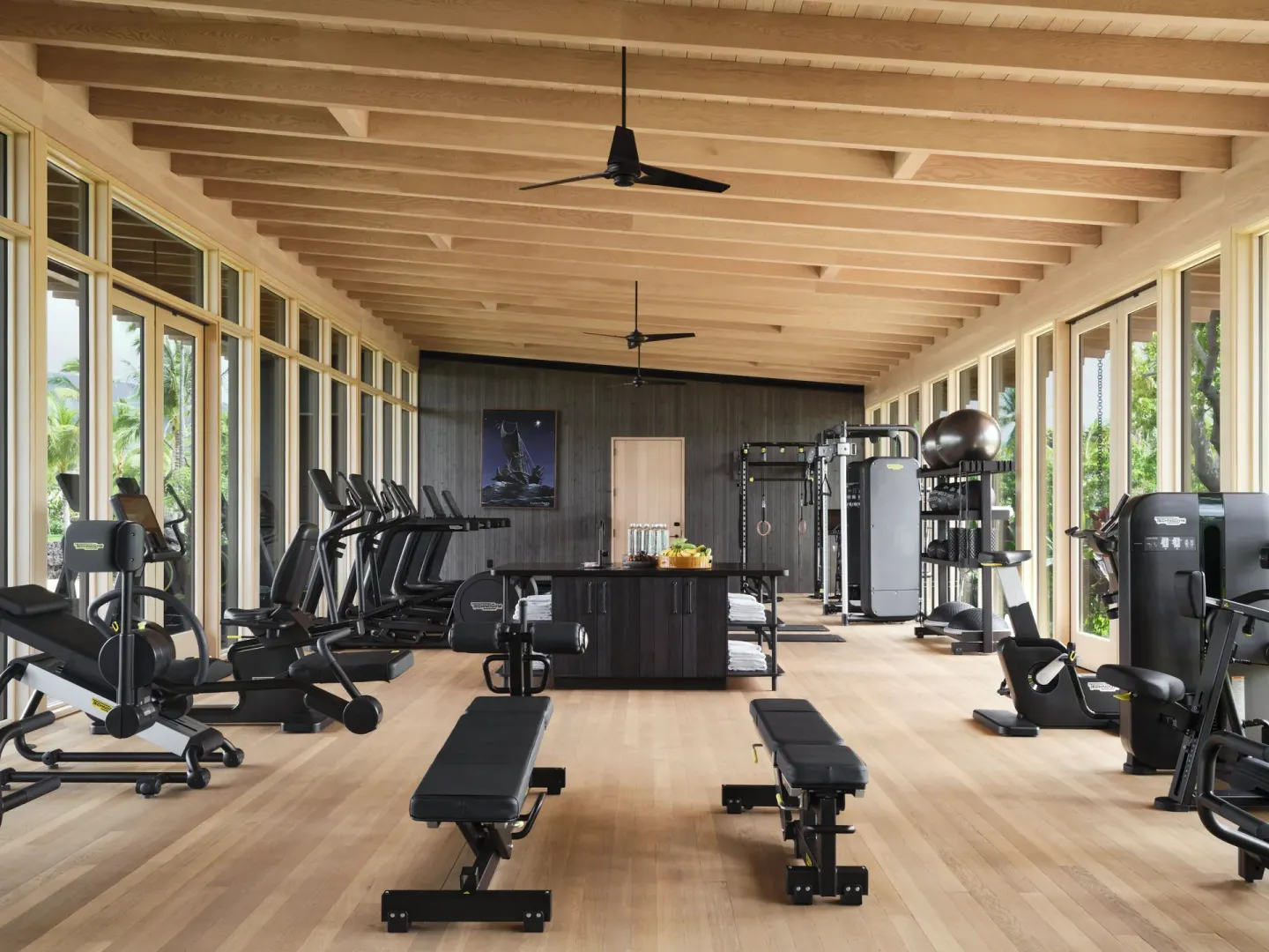 Light-filled fitness center with cardio and strength equipment at Kona Village.