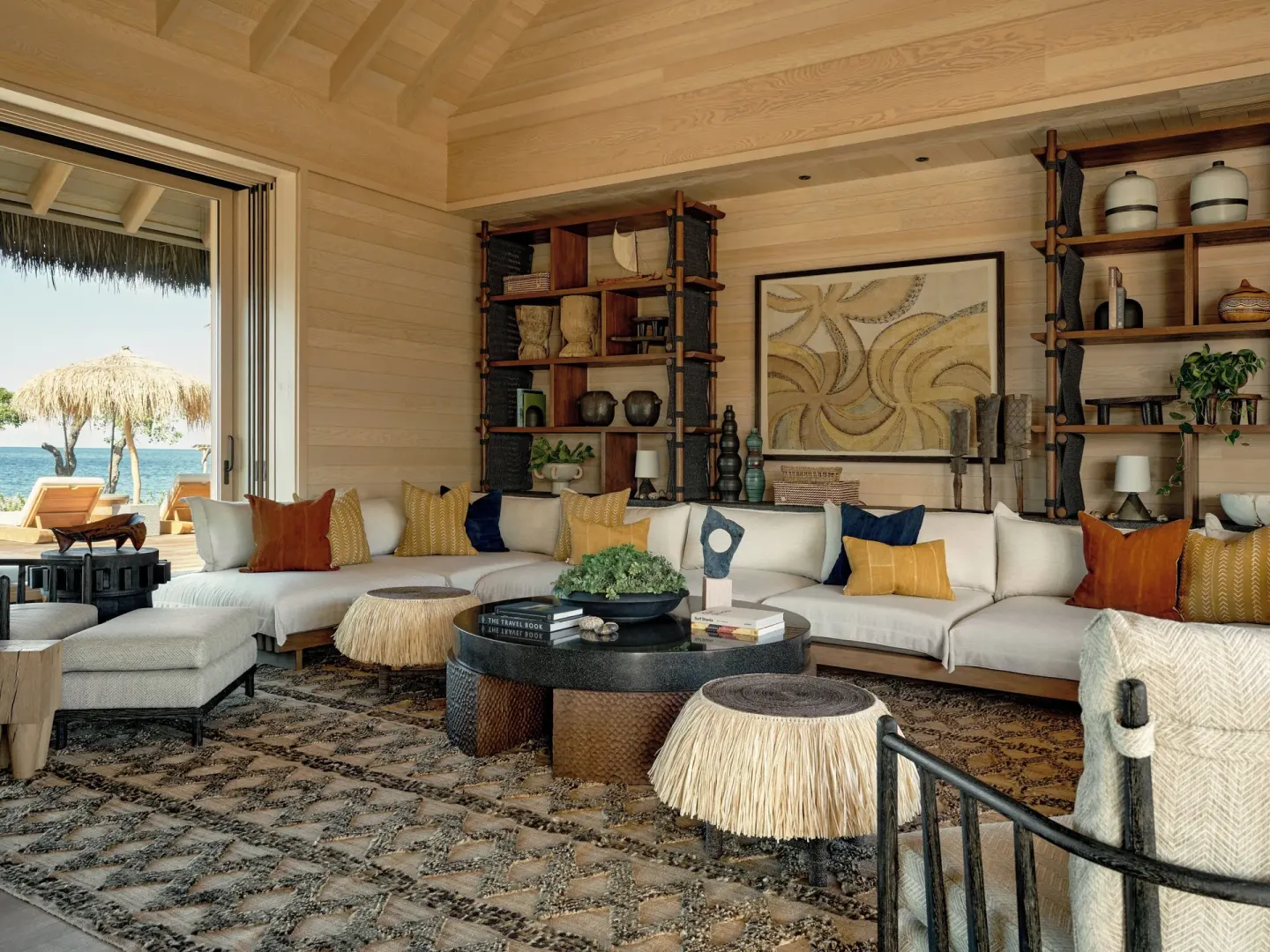 Oceanfront lounge seating with open doors and beach views at Kona Village.