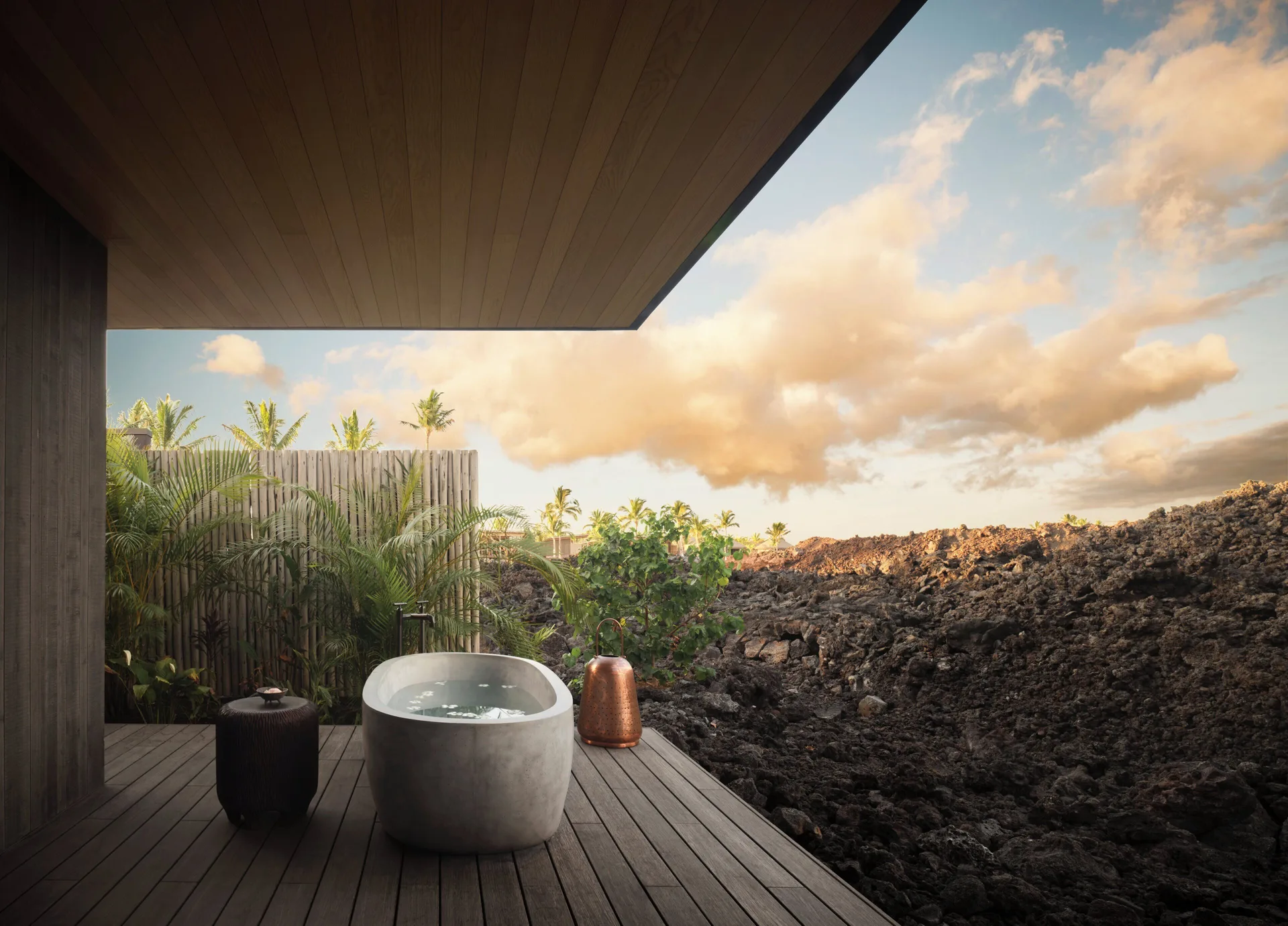 Outdoor soaking tub on a spa deck beside lava rock at Kona Village.