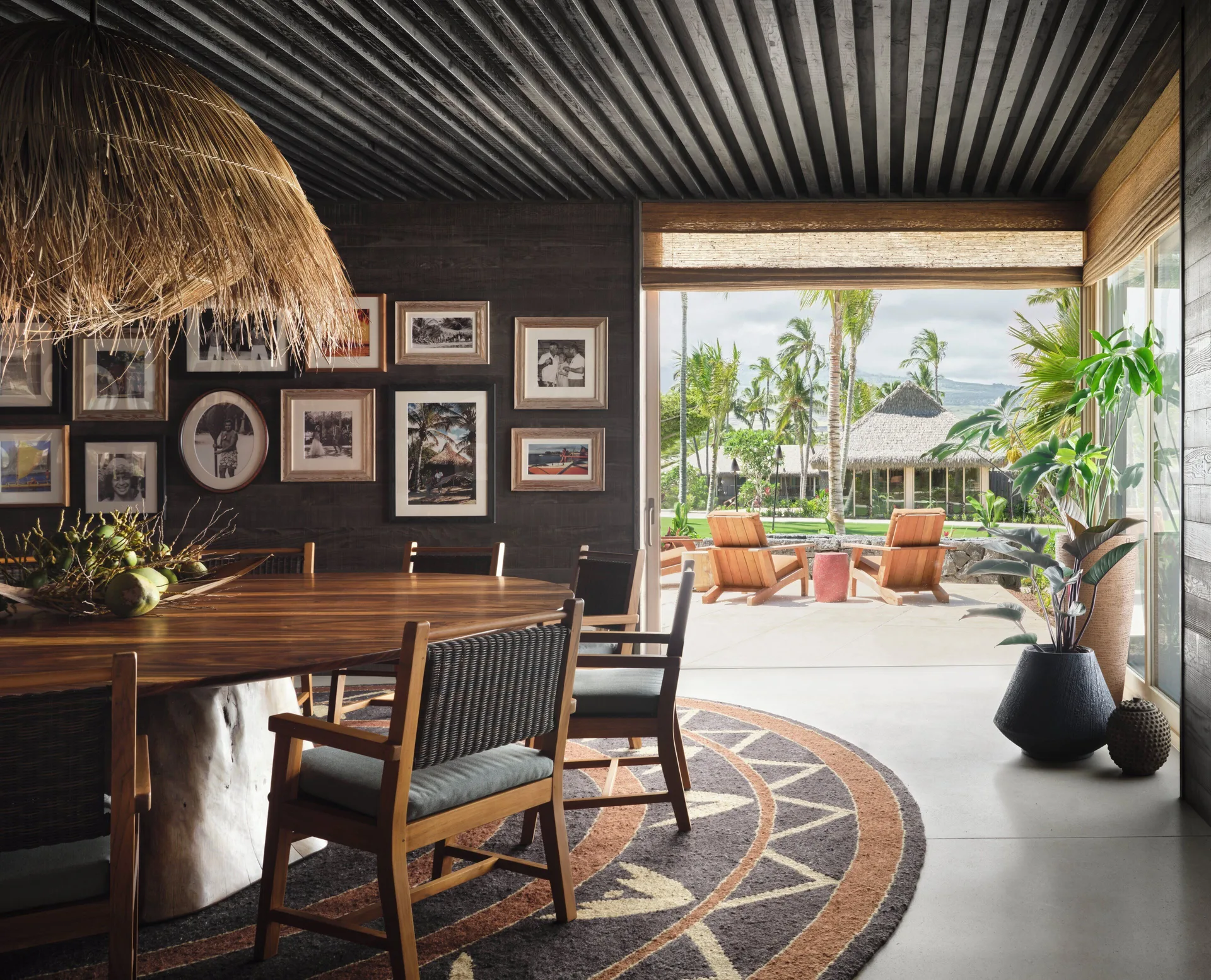 Dining room with round table and patio doors at Kona Village.