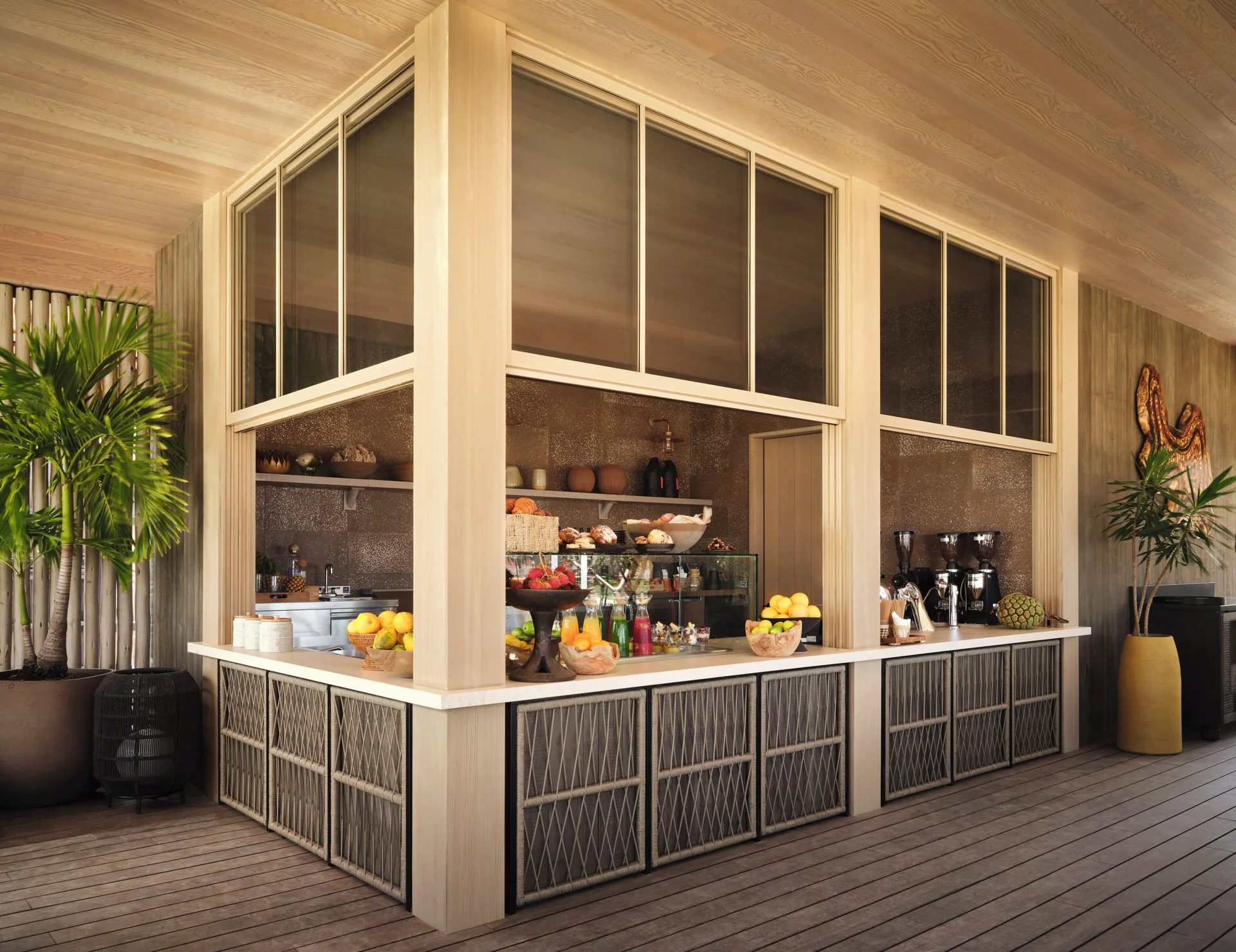 A market-style counter displays fruit, pastries and coffee equipment at Kona Village.