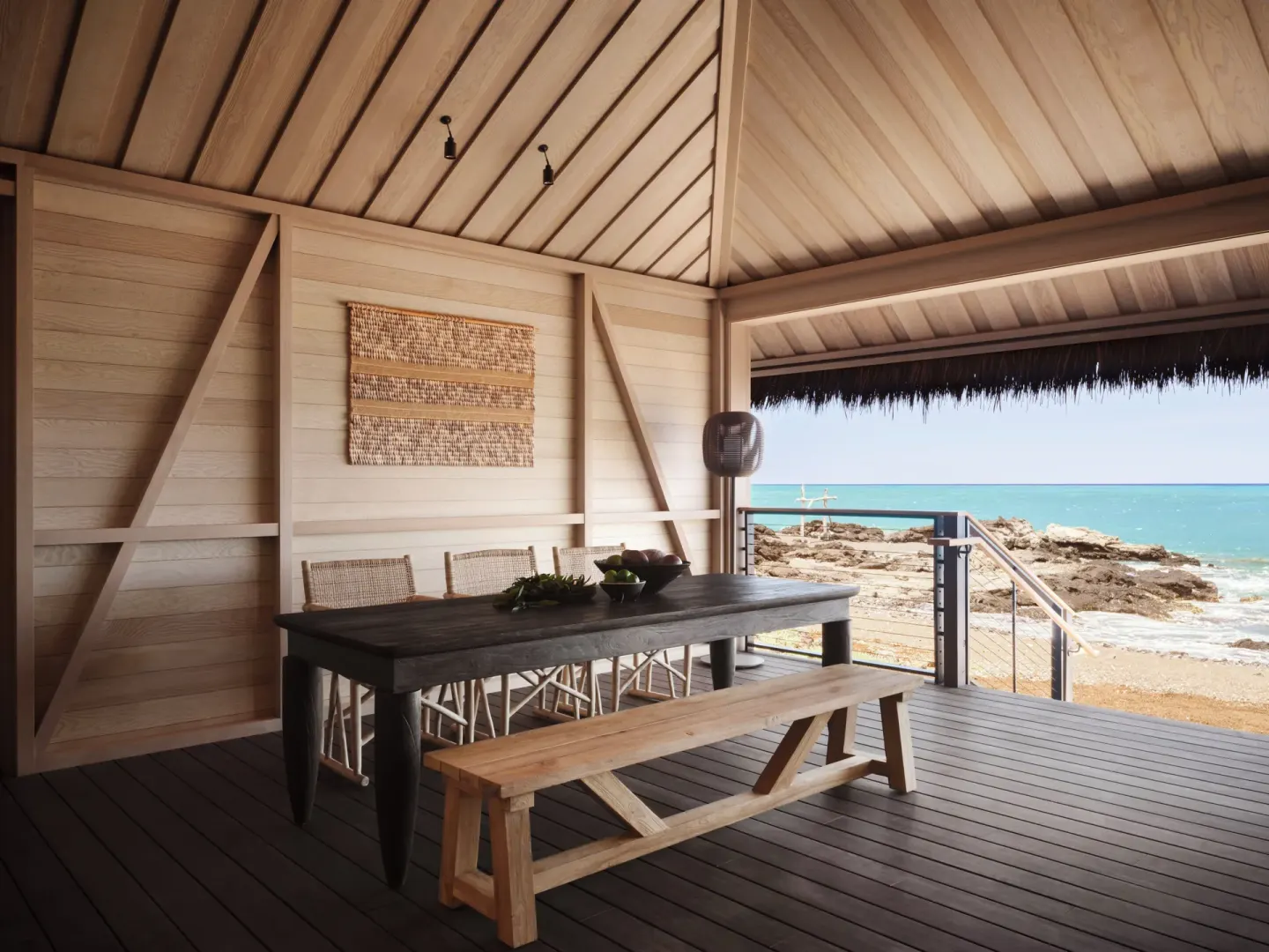 Oceanfront dining table on a covered kauhale lanai at Kona Village.