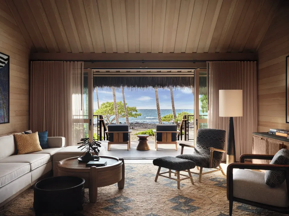 Beach Front One Bedroom Kauhale living room opening to the ocean at Kona Village.