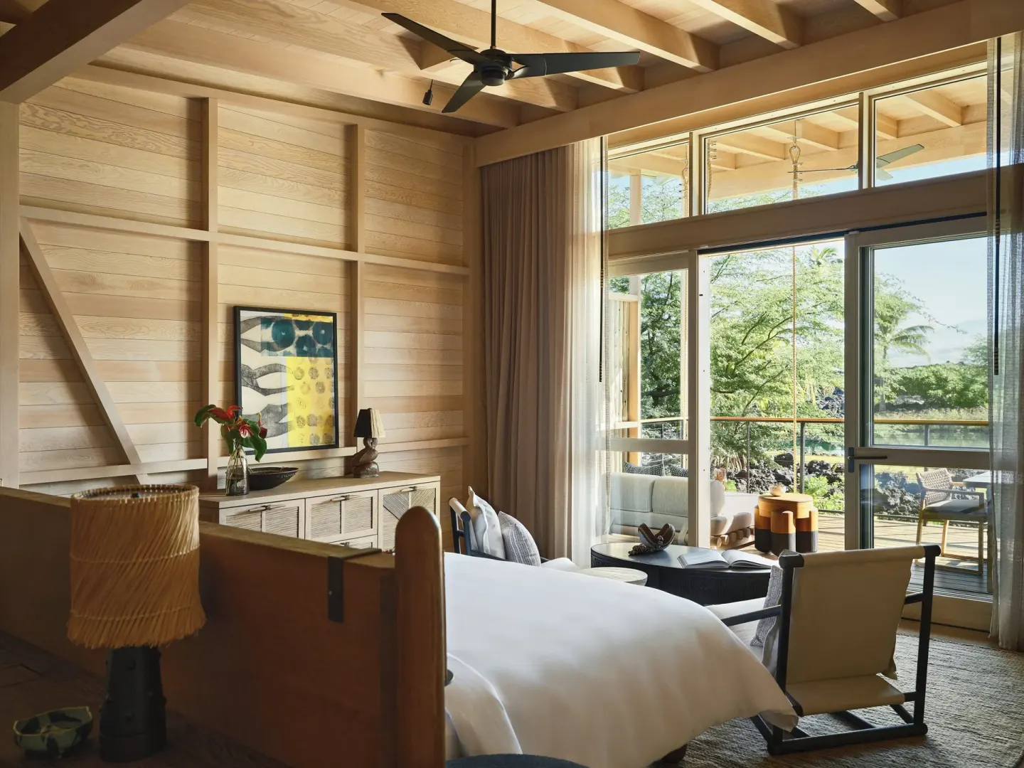Mountain View One Bedroom Kauhale bedroom opening to a furnished lanai at Kona Village.
