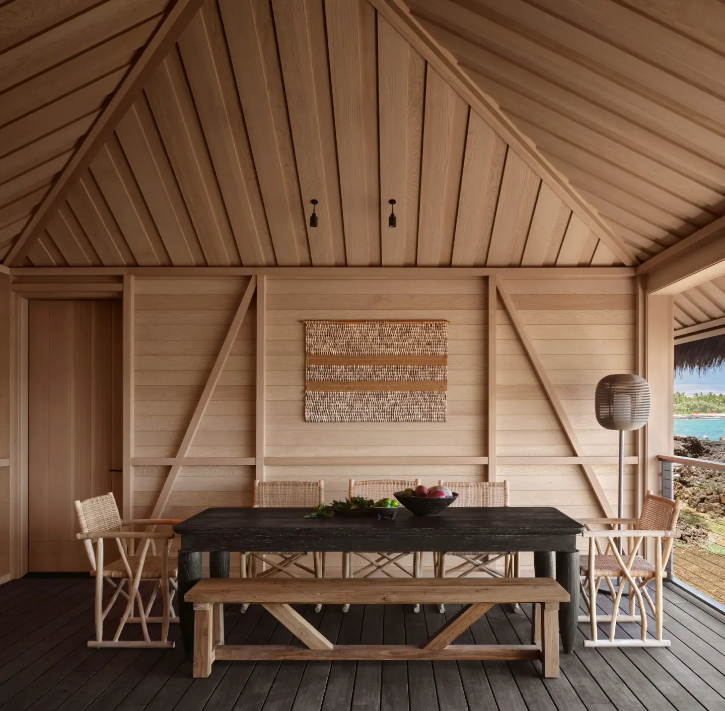 Covered dining lanai in an Ocean Front Black Sand Two Bedroom Kauhale at Kona Village.
