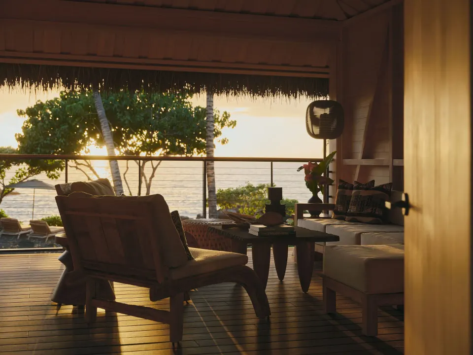 Sunset lanai seating in an Ocean Front Black Sand Two Bedroom Kauhale at Kona Village.