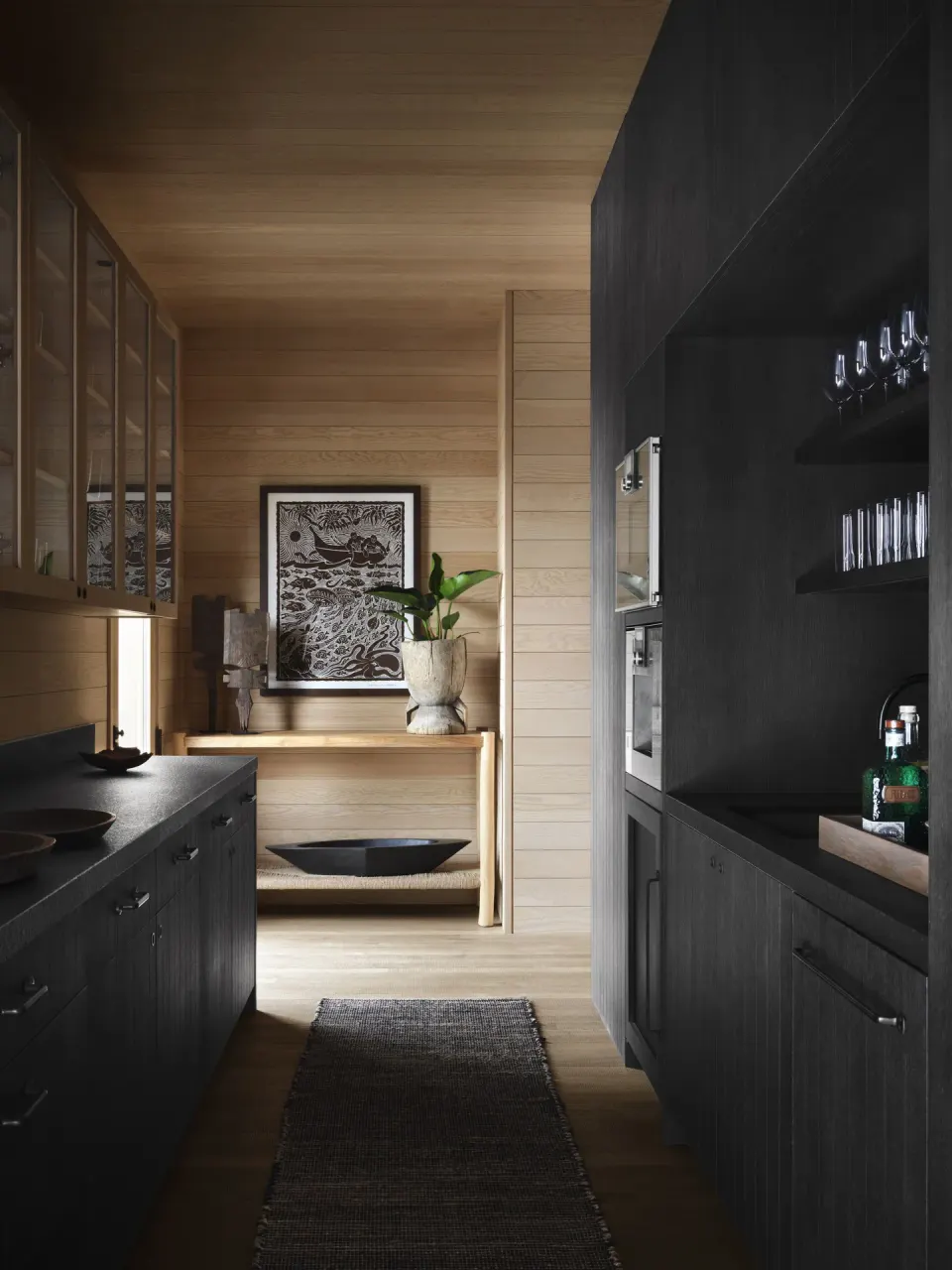 Galley kitchen and bar cabinetry in Ocean Front Four Bedroom Maheawalu Kauhale at Kona Village.