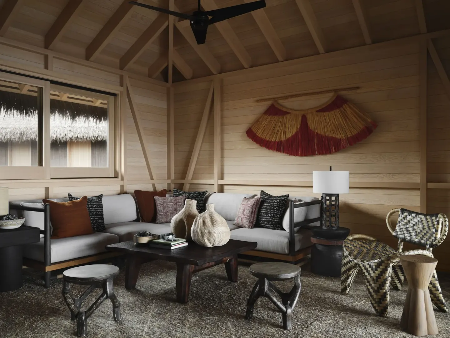 Living room seating area in Ocean Front Four Bedroom Maheawalu Kauhale at Kona Village.