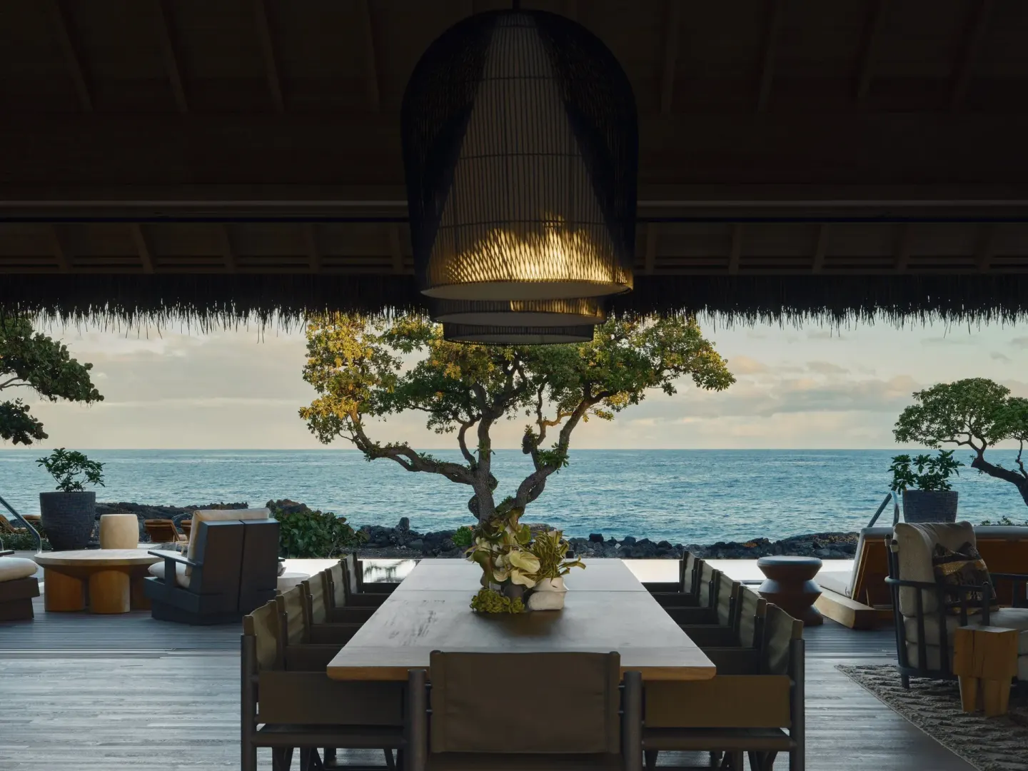 Dining table facing the ocean in Ocean Front Four Bedroom Maheawalu Kauhale at Kona Village.
