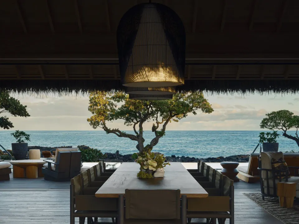 Dining table facing the ocean in Ocean Front Four Bedroom Maheawalu Kauhale at Kona Village.