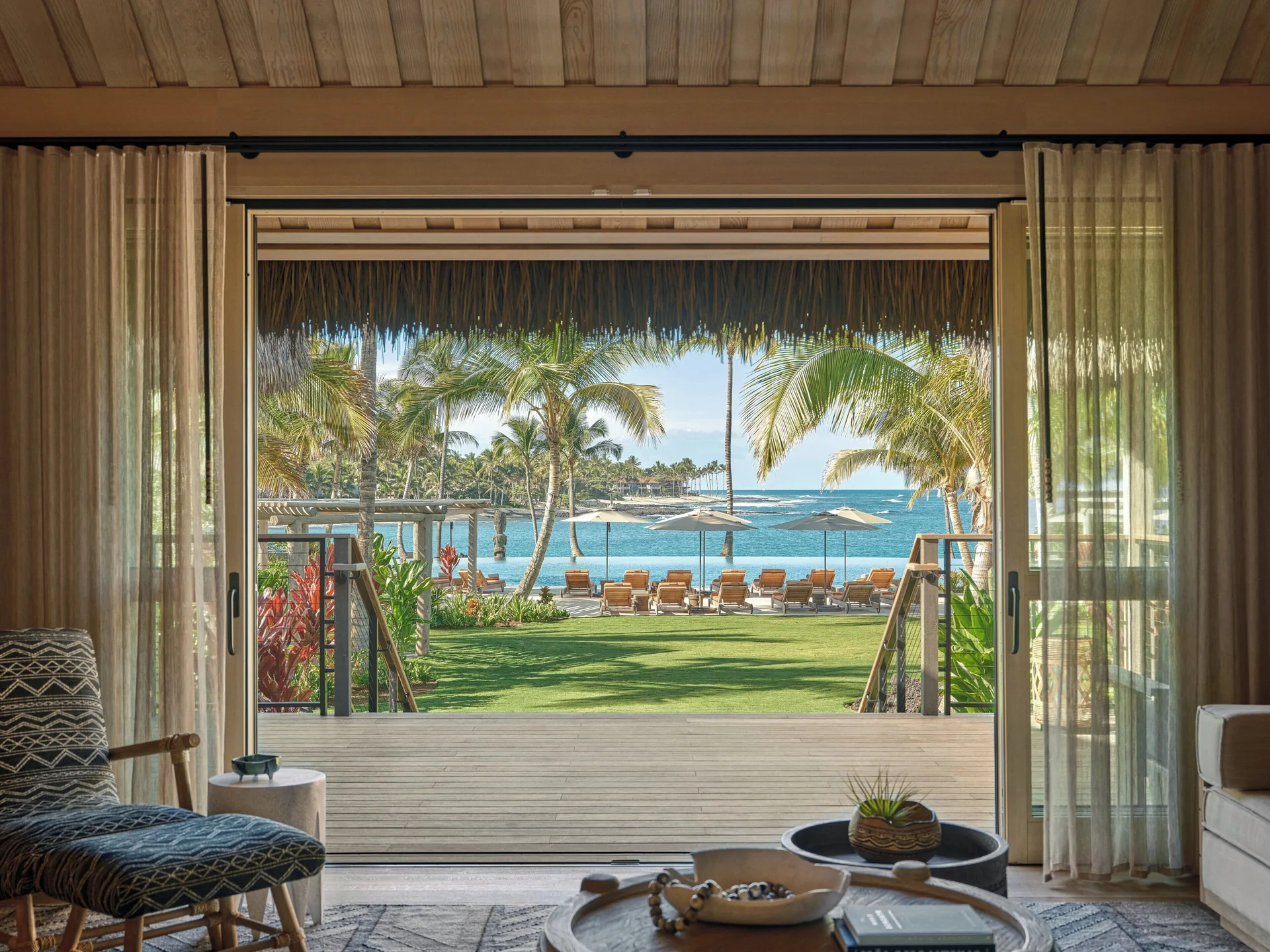 Ocean View Two Bedroom Kauhale Room at Kona Village with sitting area, ocean views, and traditional Hawaiian kauhale design on the Big Island.