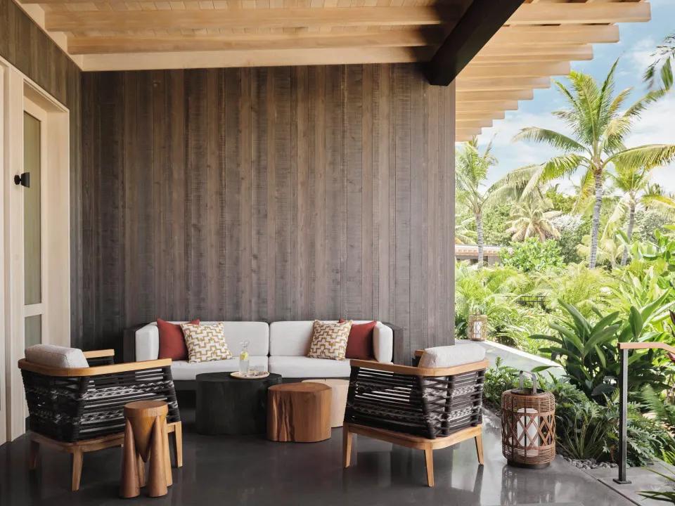 Covered lanai seating at the Ohana Pool Accessible Four Bedroom Kauhale at Kona Village.